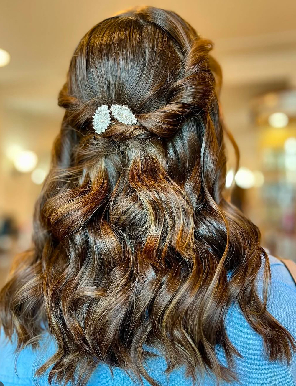 Curly hairstyle with decorative hair clip.