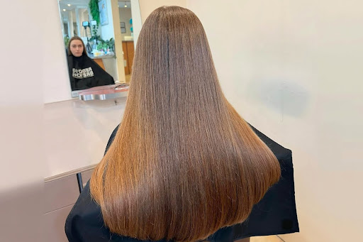 Woman with long, straight brown hair.